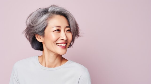 Cute smiling woman with gray hair Beautiful middle aged Asian woman Portrait. Studio photo shoot