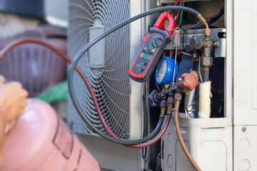 Air Conditioning Repair man hands checking and fixing modern air conditioning system, Technician team checking leakage air conditioning system