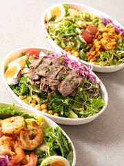 Fusilli salad, several different salads in bowls