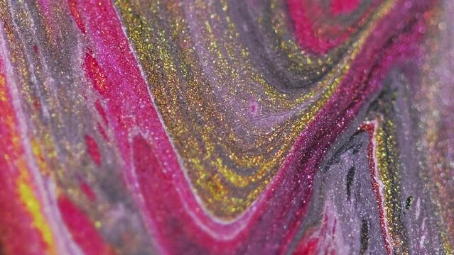 Glitter ink wave. Fluid spill. Sparkling liquid spreading. Shiny golden pink black color marble texture paint flow on defocused art abstract background.
