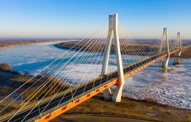 Picturesque winter landscape of Oka river with modern multi-span cable-stayed road bridge near Russian city of Murom . - obrazy, fototapety, plakaty