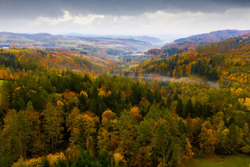 Fototapeta na wymiar Scenic aerial view of autumn hilly landscape with colored trees