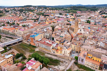 Fototapeta na wymiar Summer view from drone of center of medieval Spanish town of La Bisbal d Emporda with episcopal palace castle and Church of Santa Maria, province of Girona, Catalonia..