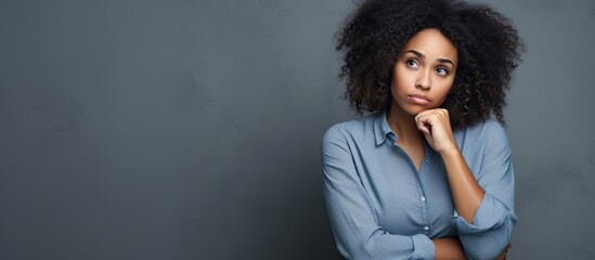 Upset African American woman skeptical and nervous about a problem, frowning and feeling negative.