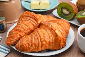 Delicious croissants on white plate 