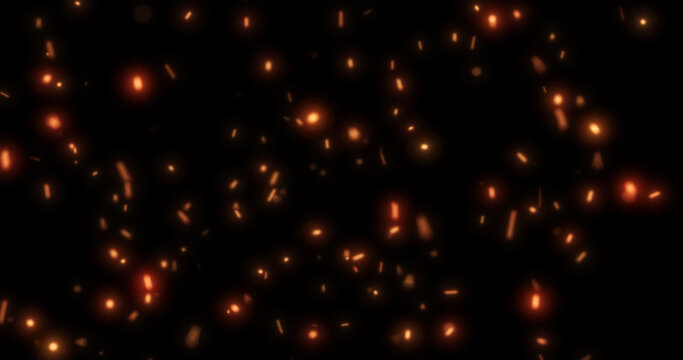 Abstract bright background of flying yellow glowing orange fire sparks from a fire on a black background
