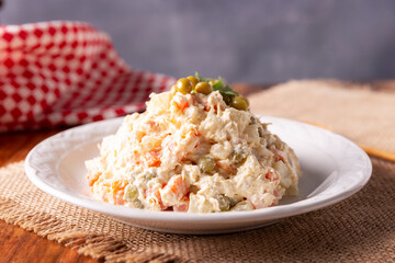 Russian Salad, also known as Olivier Salad. Very popular dish in several countries, the main ingredients are commonly potatoes, mayonnaise and vegetables such as peas, carrots, boiled eggs or chicken