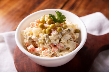 Russian Salad, also known as Olivier Salad. Very popular dish in several countries, the main ingredients are commonly potatoes, mayonnaise and vegetables such as peas, carrots, boiled eggs or chicken