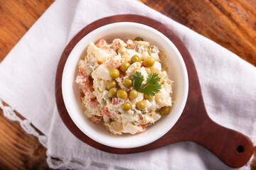 Russian Salad, also known as Olivier Salad. Very popular dish in several countries, the main ingredients are commonly potatoes, mayonnaise and vegetables such as peas, carrots, boiled eggs or chicken