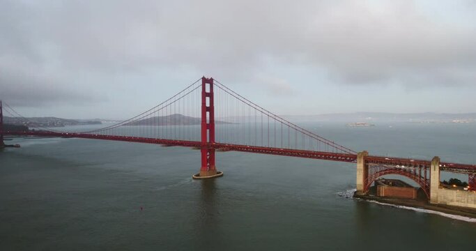 Drone shot rising in front of the Golden gate bridge, sunrise in San Francisco