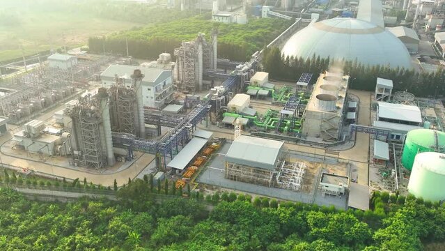 The combined-cycle power plant, viewed from above by a drone, showcases a maze of pipes and turbines, an industrial marvel of efficiency and energy production. Aerial view drone.
