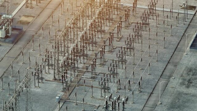 High voltage substations are crucial in electricity distribution, transforming and regulating voltage levels for efficient transmission, ensuring reliable power supply. Aerial view drone.
