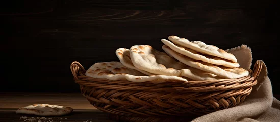 Cercles muraux Boulangerie Pita bread stored in a basket.
