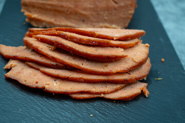 Vegan meat alternative- seitan  made with gluten and tofu, seasoned with spices, glazed with BBQ...