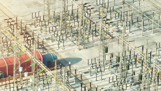 High voltage substations are vital electrical facilities that transform and distribute electricity at elevated voltages, ensuring efficient transmission and distribution of power. Aerial view drone.
