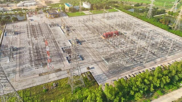 High voltage substations are essential components of the electrical grid, serving to transform and distribute electricity at elevated voltages efficiently. Aerial view drone.
