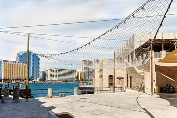 Fototapeta premium The Dubai Creek near the reconstructed old part of the Dubai city - Al-Bastakiya quarter in the Dubai city, United Arab Emirates