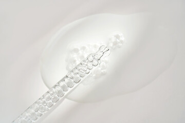 A transparent pipette of serum under the morning sun.