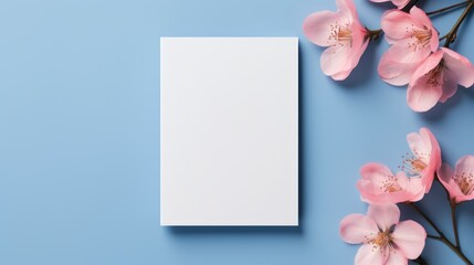 Blank greeting card with pink sakura flowers on blue background.