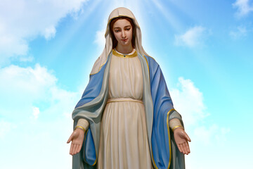 Our lady of grace virgin Mary with Bright Blue Sky and beautiful clouds with abstract colored background and wallpaper.