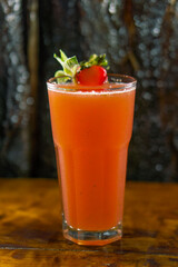 glass of juice with a strawberry decoration