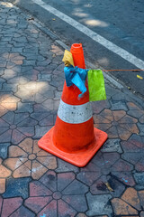 a traffic cone on the sidewalk