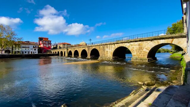 Low angle view of roman bridge of Aquae Flaviae, Chaves Vila Real Portugal at sunrise as water flows below