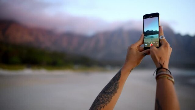 Phone screen, hands and beach photography for travel, freedom or content creation in nature. Smartphone, app and traveling influencer person at the ocean recording for social media, blog or memory