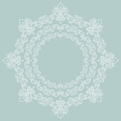 Oriental ornament with arabesques and floral elements. Traditional classic ornament. Round light blue and white vintage pattern with arabesques