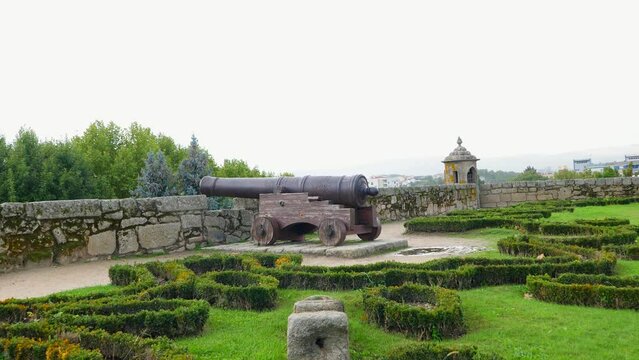 Pan across large cannons protecting castle parapet battlement lawn in Chaves Vila Real Portugal