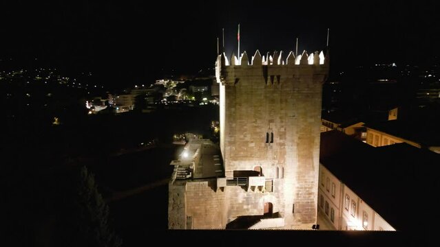 Drone right to left orbit around castle tower at night in Chaves Vila Real Portugal