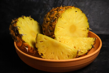 pineapple cut into pieces and served on a plate
