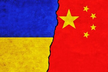 Ukraine and China painted flags on a wall with a crack. China and Ukraine relations. Ukraine and China flags together