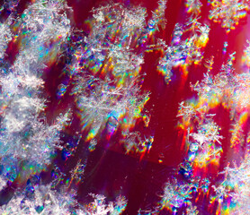 Fototapeta na wymiar Close-up of snowflakes on a red background. Macro