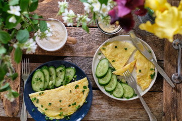 breakfast. Fried eggs on with cucumber. Wooden background, top view