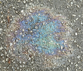 A trace of gasoline on the asphalt as a background. Texture