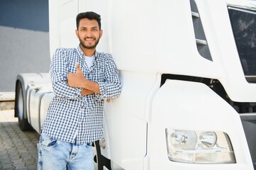 Young indian man standing by his truck. The concept of freight transportation.