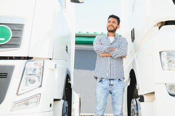 Young indian man standing by his truck. The concept of freight transportation.