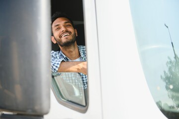 Young Indian truck driver. Concept of road freight transportation.