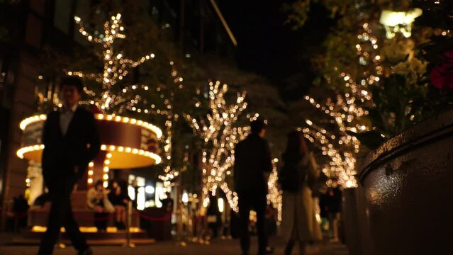 TOKYO, JAPAN - DECEMBER 2023 : View of Christmas illumination light up at Marunouchi area. Japanese winter city and romantic Christmas night concept video. Time lapse shot.