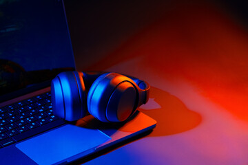 Headphones on a computer keyboard on black background
