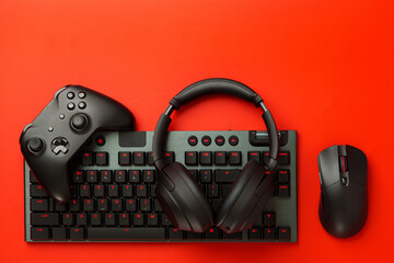 Gamer equipment on red background top view