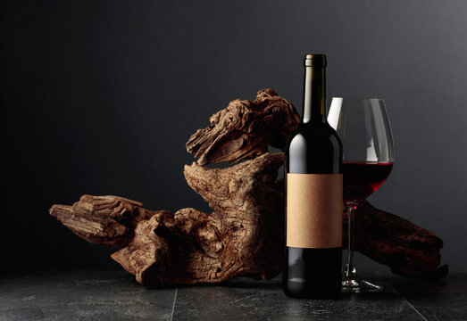 Bottle and glass of red wine with old empty label.