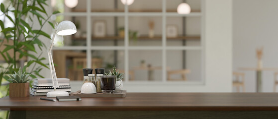Wooden table in a study room with coffee cup on the table and blurred background living room.