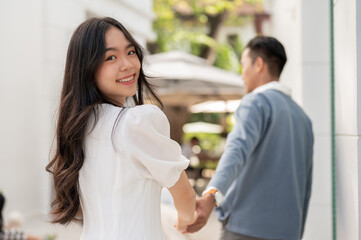 Young lovely adorable Asian couple spending time together, hugging and holding and holding hand.