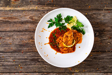 Roast chicken breast in bbq sauce on wooden table
