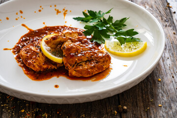 Roast chicken breast in bbq sauce on wooden table
