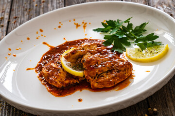 Roast chicken breast in bbq sauce on wooden table
