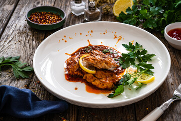Roast chicken breast in bbq sauce on wooden table