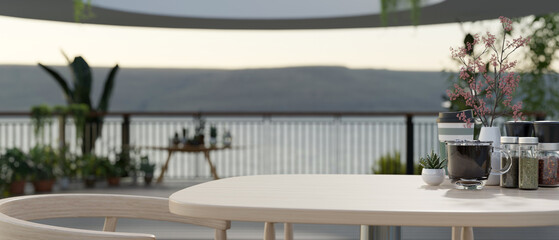 Close-up image of an empty space on a wooden table on a beautiful spacious balcony with garden.